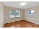 Bright bedroom with hardwood floors and two windows at 3003 River Rd, Shelby, NC 28152