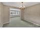 Bright dining room, featuring a chandelier and view into adjacent room at 3003 River Rd, Shelby, NC 28152