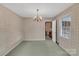 Charming dining room with patterned wallpaper and a chandelier at 3003 River Rd, Shelby, NC 28152