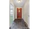 Inviting entryway with slate tile floor and wood door at 3003 River Rd, Shelby, NC 28152