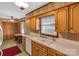 Kitchen with wood cabinets, double sink, and window above the sink at 3003 River Rd, Shelby, NC 28152