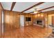 Living room featuring hardwood floors, a brick fireplace and exposed beams at 3003 River Rd, Shelby, NC 28152