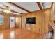 Bright living room featuring hardwood floors, exposed beams, and a brick fireplace at 3003 River Rd, Shelby, NC 28152