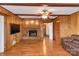 Living room with hardwood floors, brick fireplace, and ceiling fan at 3003 River Rd, Shelby, NC 28152