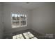 Well-lit bedroom featuring a large window and neutral walls at 3015 Buffet Ln, Monroe, NC 28110