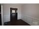 Bright dining room with dark hardwood floors and wainscoting at 3015 Buffet Ln, Monroe, NC 28110