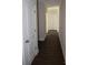 Long hallway with dark hardwood floors and white doors at 3015 Buffet Ln, Monroe, NC 28110