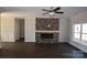 Living room with stone fireplace and dark hardwood floors at 3015 Buffet Ln, Monroe, NC 28110