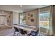 Bright dining area with modern table and chairs, hardwood floors, and large windows at 3048 Ora Smith Rd, Lincolnton, NC 28092