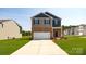 Two-story brick home with a two-car garage and landscaped lawn at 3048 Ora Smith Rd, Lincolnton, NC 28092