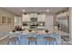 Kitchen island with granite countertop, sink, and seating for three at 3048 Ora Smith Rd, Lincolnton, NC 28092