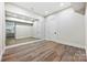 Spacious basement featuring a mirrored wall and hardwood floors at 3319 Gresham Pl, Charlotte, NC 28211