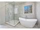 Modern bathroom featuring a standalone tub, glass shower, and elegant tile work at 3319 Gresham Pl, Charlotte, NC 28211