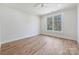 Airy bedroom featuring hardwood floors and a large window showcasing the outdoor scenery at 3319 Gresham Pl, Charlotte, NC 28211