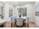 Bright dining area features large windows and a chandelier, offering a cozy and inviting space at 3319 Gresham Pl, Charlotte, NC 28211