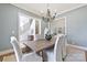 Stylish dining room with seating for six, light blue walls, hardwood floors, and views to the foyer at 3319 Gresham Pl, Charlotte, NC 28211