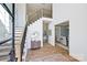 Bright foyer with staircase, hardwood floors, elegant decor, and views into the living and dining rooms at 3319 Gresham Pl, Charlotte, NC 28211