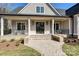 Close-up of the front entrance featuring a brick walkway, covered porch, and black-framed glass doors at 3319 Gresham Pl, Charlotte, NC 28211