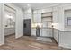 Bright kitchenette featuring white cabinetry, stainless appliances and tile backsplash at 3319 Gresham Pl, Charlotte, NC 28211