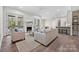 Bright living room featuring a fireplace, hardwood floors, french doors and access to an outdoor patio at 3319 Gresham Pl, Charlotte, NC 28211