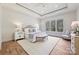 Bright main bedroom features a tray ceiling, large windows, and a cozy sitting area at 3319 Gresham Pl, Charlotte, NC 28211