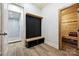 Mud room featuring custom storage cabinets, bench, and access to a bathroom and sauna at 3319 Gresham Pl, Charlotte, NC 28211