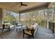 Relaxing covered porch features wood-look flooring, comfortable seating, ceiling fan and wooded view at 3319 Gresham Pl, Charlotte, NC 28211