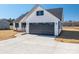 New construction home with gray garage door and driveway at 343 North Brook Iii School Rd, Vale, NC 28168