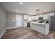 Modern kitchen with white cabinets, quartz island, and stainless steel appliances at 343 North Brook Iii School Rd, Vale, NC 28168