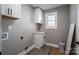 Bright laundry room with white cabinets and vinyl flooring at 343 North Brook Iii School Rd, Vale, NC 28168