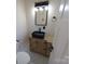 Modern bathroom with a black vessel sink, wood vanity, and marble tile floor at 4165 Laurelwood Ct, Concord, NC 28025