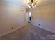 Well-lit bedroom with neutral carpeting and an ensuite bathroom at 4165 Laurelwood Ct, Concord, NC 28025