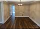 Bright dining room with hardwood floors and a modern chandelier at 4165 Laurelwood Ct, Concord, NC 28025