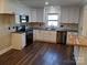 Renovated kitchen, featuring white cabinets, stainless steel appliances, and dark hardwood floors at 4165 Laurelwood Ct, Concord, NC 28025