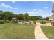 Landscaped backyard with stone path to pool at 498 New Salem Rd, Statesville, NC 28625