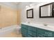 Bathroom with teal double vanity and beige tile at 498 New Salem Rd, Statesville, NC 28625