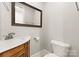 Powder room with marble vanity and wood cabinet at 498 New Salem Rd, Statesville, NC 28625