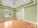 Light green bedroom with hardwood floors and ceiling fan at 498 New Salem Rd, Statesville, NC 28625