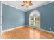 Light and airy bedroom with hardwood floors and arched window at 498 New Salem Rd, Statesville, NC 28625