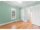 Light green bedroom with hardwood floors and white doors at 498 New Salem Rd, Statesville, NC 28625