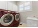 Laundry room with washer, dryer, cabinets, and utility sink at 498 New Salem Rd, Statesville, NC 28625