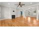 Spacious living room featuring hardwood floors, fireplace, and ceiling fan at 498 New Salem Rd, Statesville, NC 28625