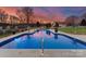 Inviting in-ground pool with lighting, at dusk at 498 New Salem Rd, Statesville, NC 28625