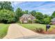 Brick home with a long driveway and lush landscaping at 508 Cobbs Glen Ct, Rock Hill, SC 29732