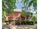 Brick house with a large deck and screened porch, surrounded by lush landscaping at 508 Cobbs Glen Ct, Rock Hill, SC 29732