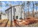 Home's rear elevation, showcasing a patio and wooded area at 5510 Brickstone Dr, Charlotte, NC 28227