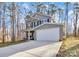 Two-story house with gray siding, white garage door, and a concrete driveway at 5510 Brickstone Dr, Charlotte, NC 28227