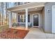 Covered front porch with rocking chairs and a view of the yard at 5510 Brickstone Dr, Charlotte, NC 28227