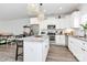 Modern kitchen with white cabinets, granite countertops, and island with seating at 5510 Brickstone Dr, Charlotte, NC 28227