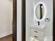 Contemporary powder room, featuring a floating vanity and illuminated mirror at 5700 Mcwhorter Rd, Waxhaw, NC 28173